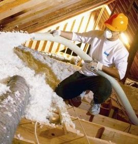 blown insulation being installed in attic